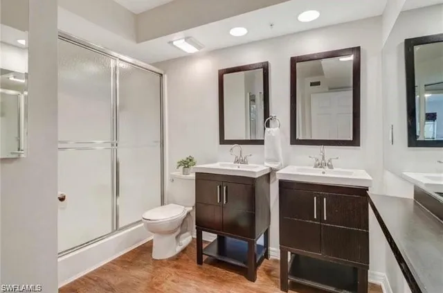 a spacious bathroom with a double vanity sink mirror and toilet