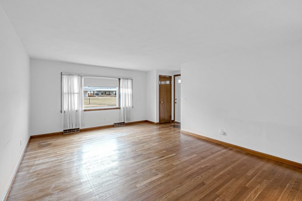 78 Scarsdale Road Springfield, MA 01129 - Photo 3 of 24 an empty room with wooden floor and windows
