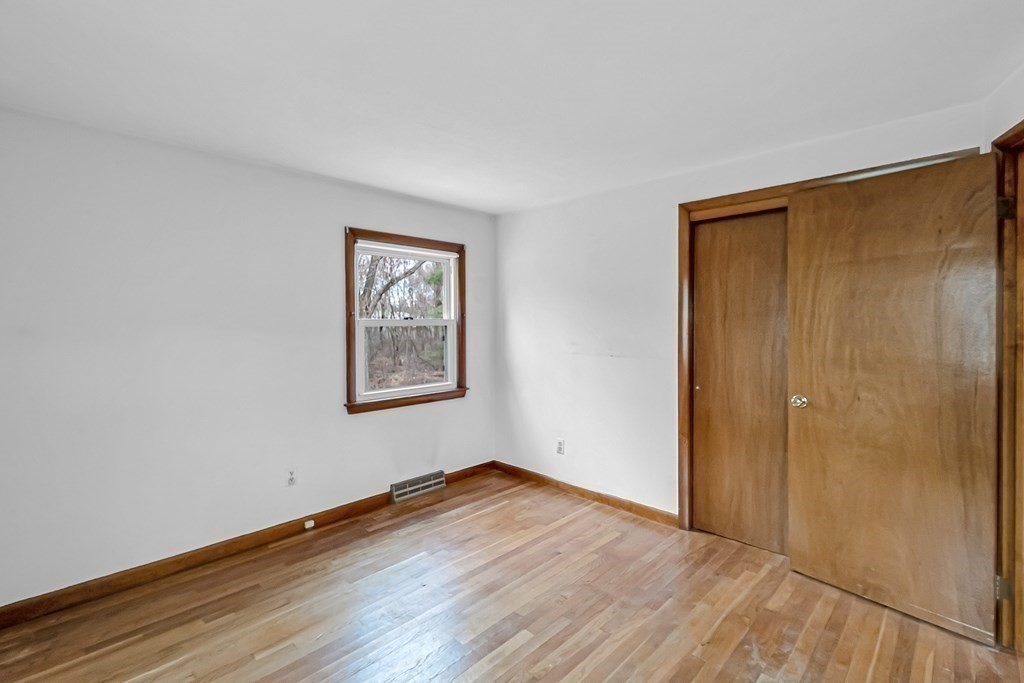 78 Scarsdale Road Springfield, MA 01129 - Photo 9 of 24 a view of an empty room with wooden floor and a window