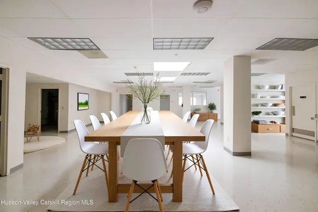 a dining room with furniture and window