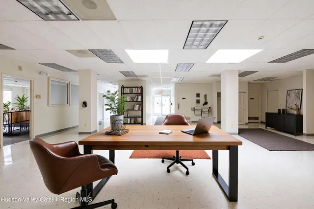 a view of a livingroom with furniture and a table