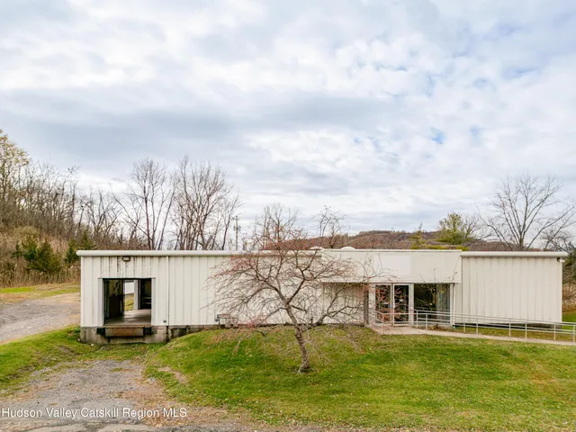 a view of a swimming pool with an outdoor seating and a yard