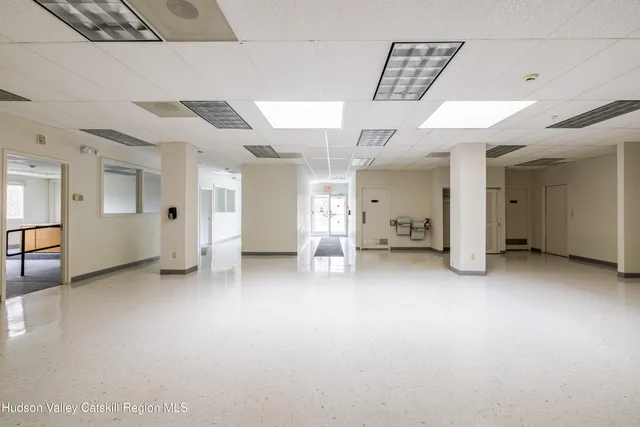 an empty room with a empty space and windows