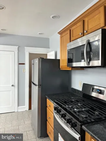 a kitchen with stainless steel appliances granite countertop a stove and a microwave