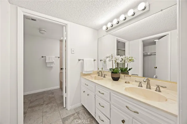 a spacious bathroom with a double vanity sink mirror and double