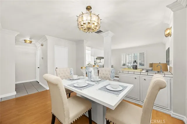 a view of a dining room with furniture and chandelier