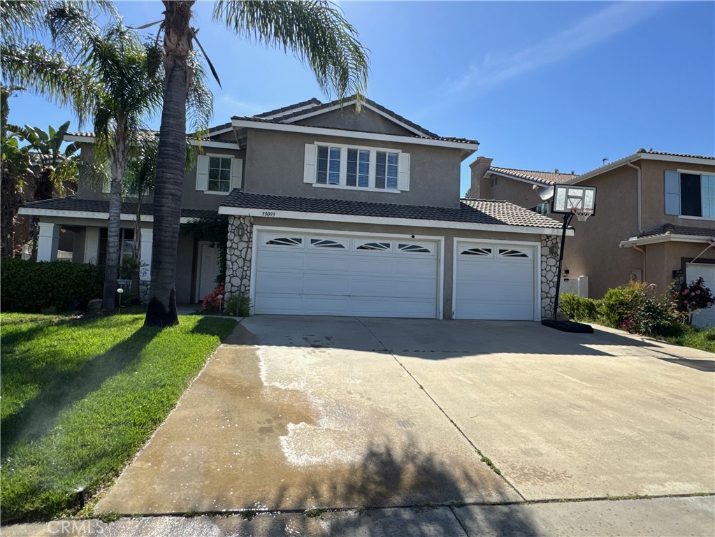 a front view of a house with a yard and garage