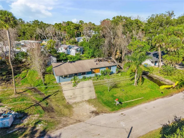 an aerial view of a house with yard swimming pool and outdoor seating