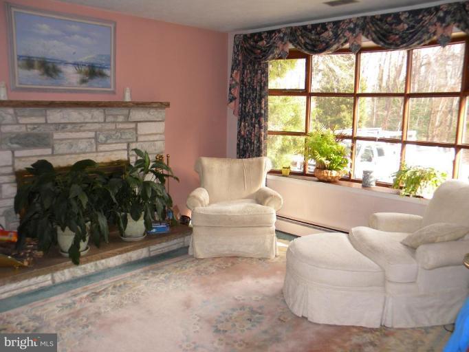 1830 Cedar Road Pasadena, MD 21122 - Photo 2 of 28 Living room with fireplace and bay window
