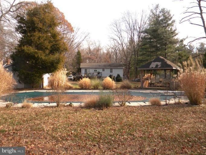 1830 Cedar Road Pasadena, MD 21122 - Photo 13 of 28 Pool area looking at Tiki bar and back of home!