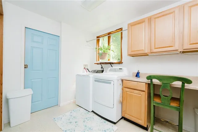 a utility room with sink dryer and washer