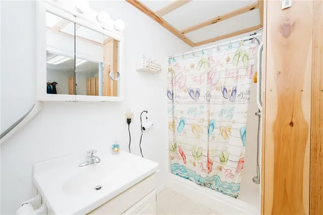 a bathroom with a shower curtain and a sink