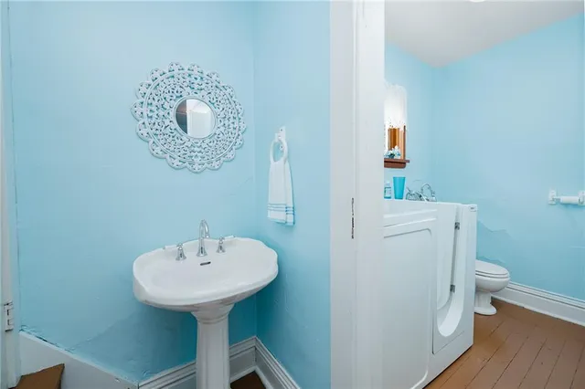 a bathroom with a sink toilet and a mirror