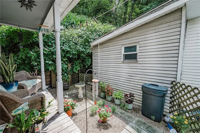 a view of a patio with table and chairs and potted plants