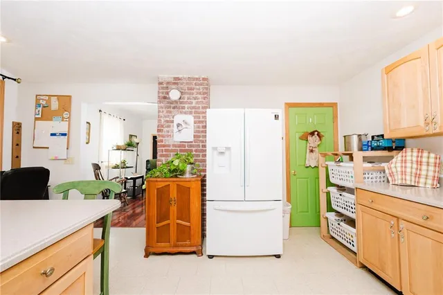 a kitchen that has a refrigerator and a stove