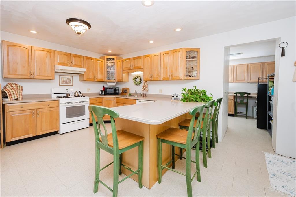 634 Ridge Avenue Ford City, PA 16226 - Photo 9 of 30 a kitchen with a dining table chairs and refrigerator