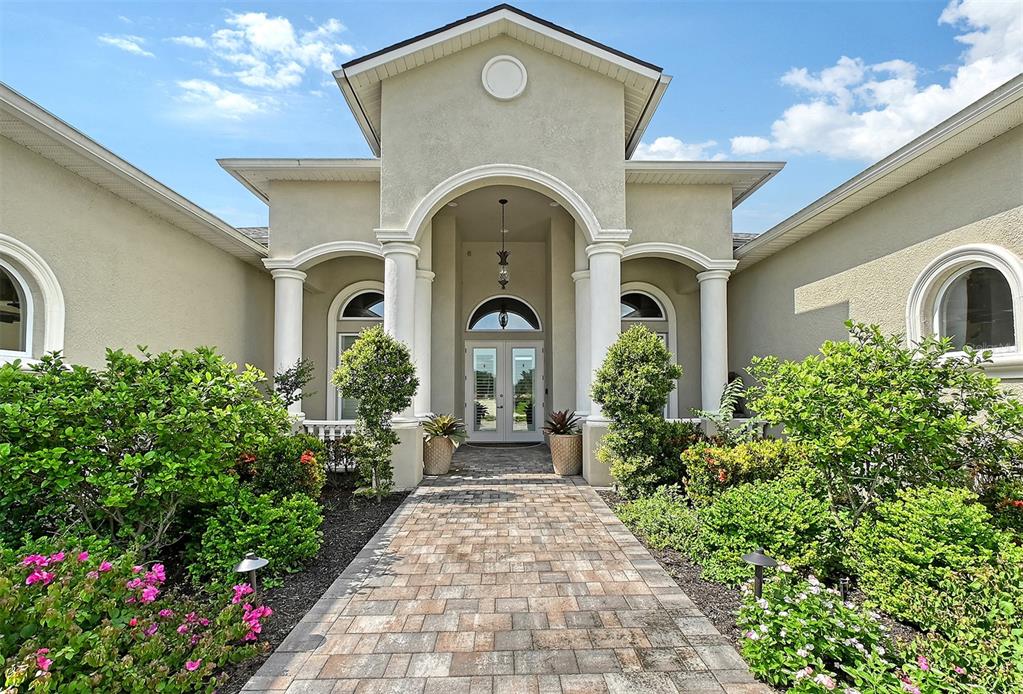 520 Rye Road Northeast Bradenton, FL 34212 - Photo 3 of 88 a front view of a house with lots of flower garden