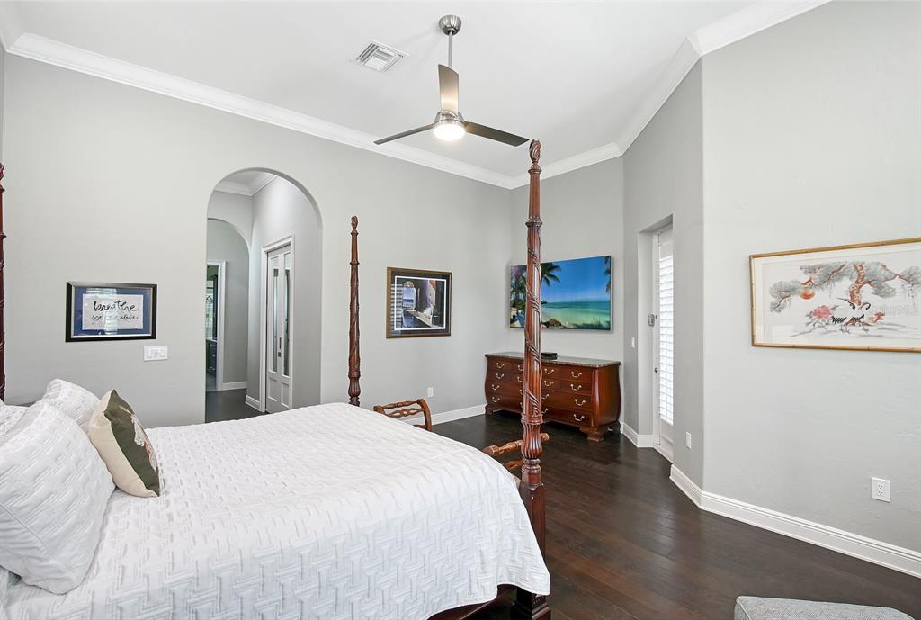 520 Rye Road Northeast Bradenton, FL 34212 - Photo 34 of 88 a bedroom with a large bed and a chandelier