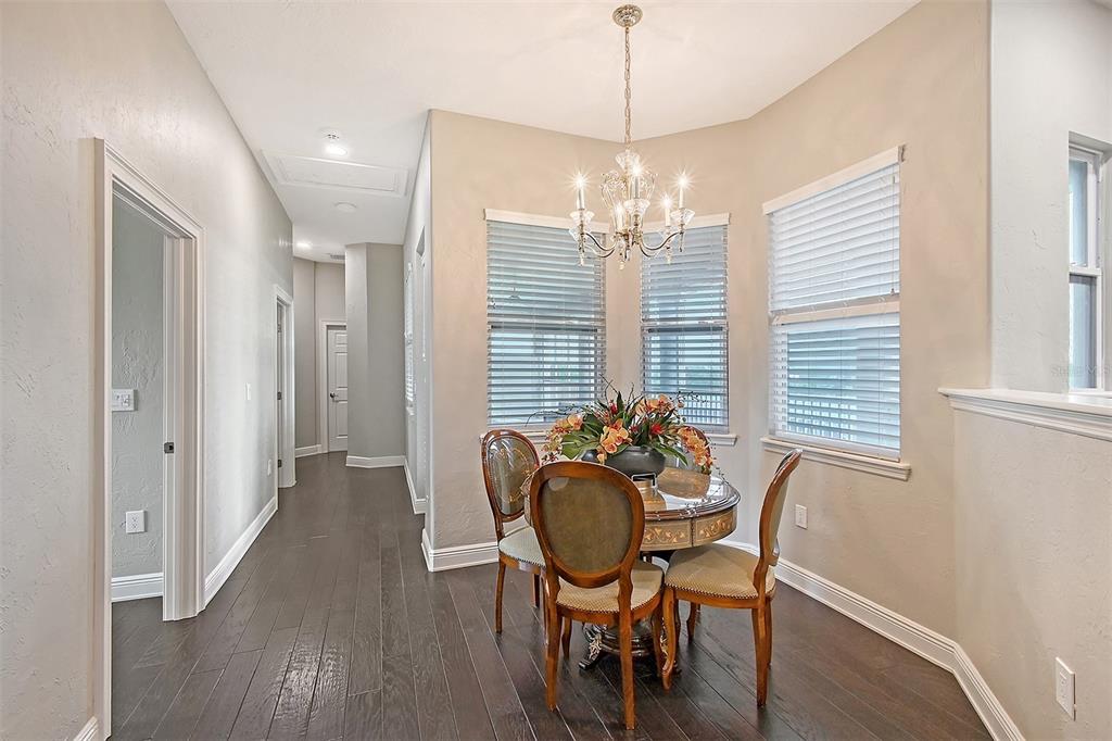 520 Rye Road Northeast Bradenton, FL 34212 - Photo 44 of 88 a view of a dining room with furniture wooden floor and chandelier