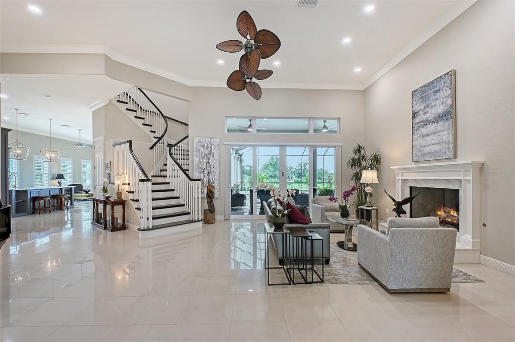 520 Rye Road Northeast Bradenton, FL 34212 - Photo 5 of 88 a living room with furniture stairs and a large window