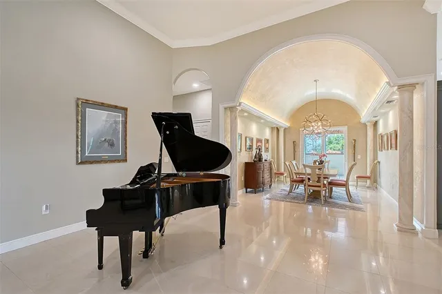 a living room with furniture and a chandelier