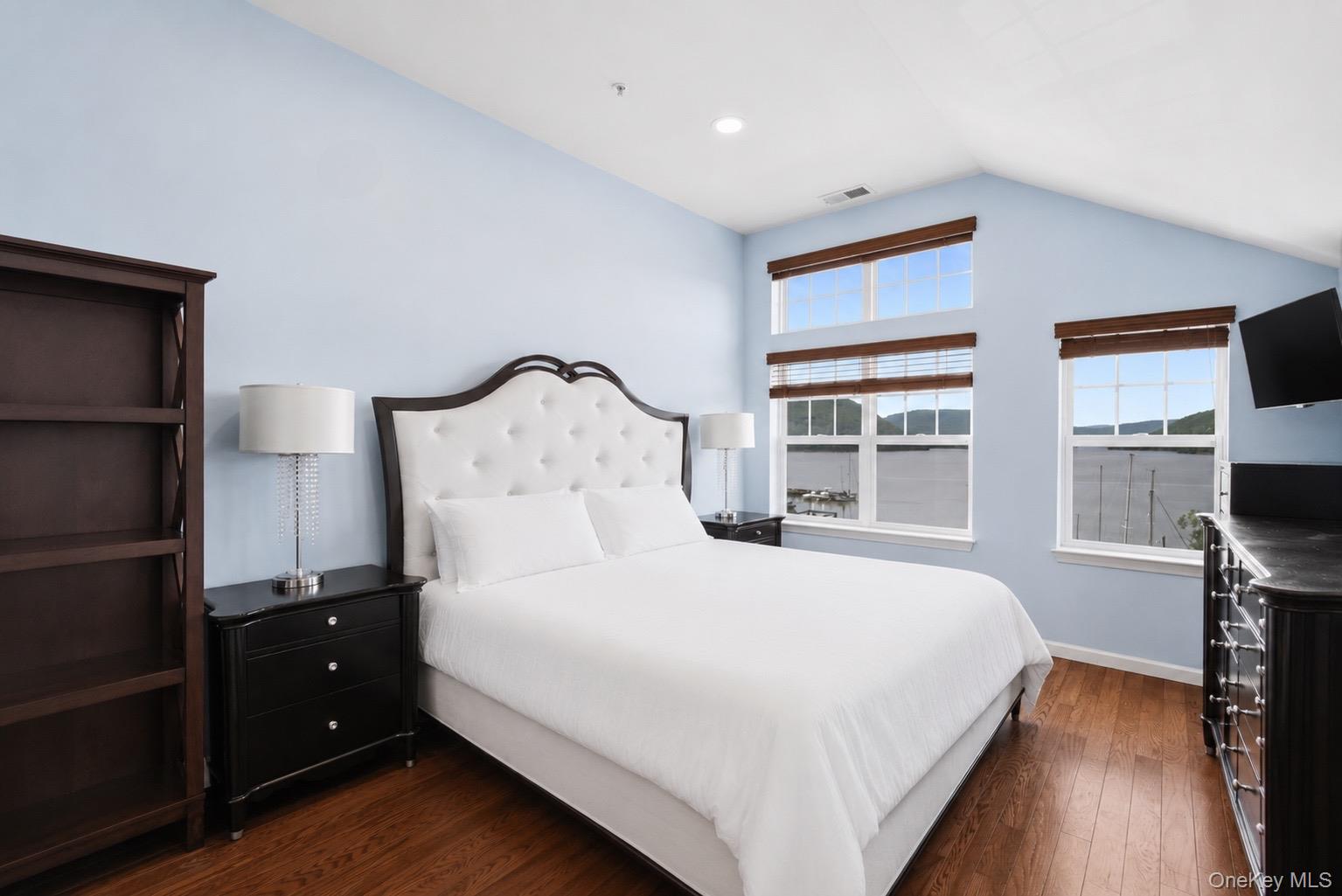 323 Waterside Close Peekskill, NY 10566 - Photo 15 of 42 Primary bedroom has vaulted ceiling, new recessed lights, walk-in closet, HWF, and a large window array with views of the Hudson River and Bear Mountain