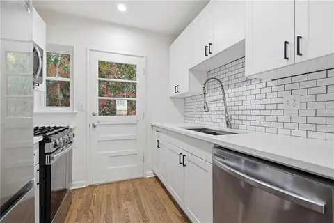 a kitchen with a sink and cabinets