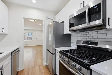 a kitchen with a stove and a microwave