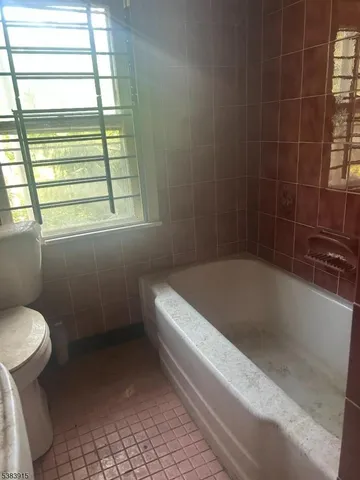 a white bath tub sitting next to a toilet