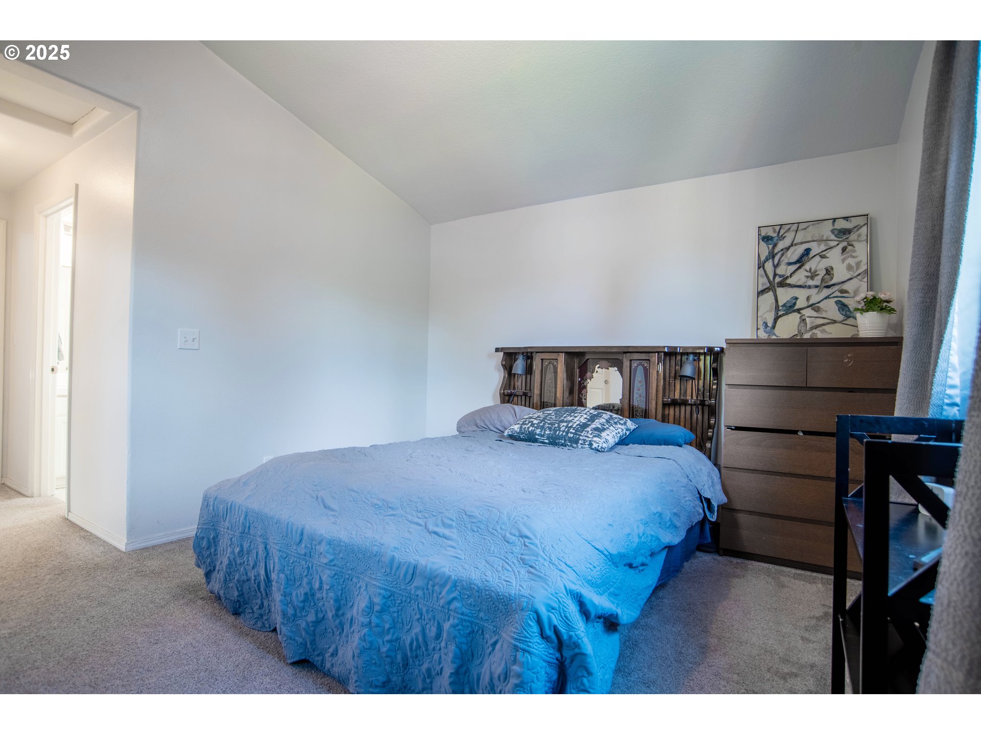 9809 North Exeter Avenue Portland, OR 97203 - Photo 13 of 31 a bedroom with a bed and painting on the wall