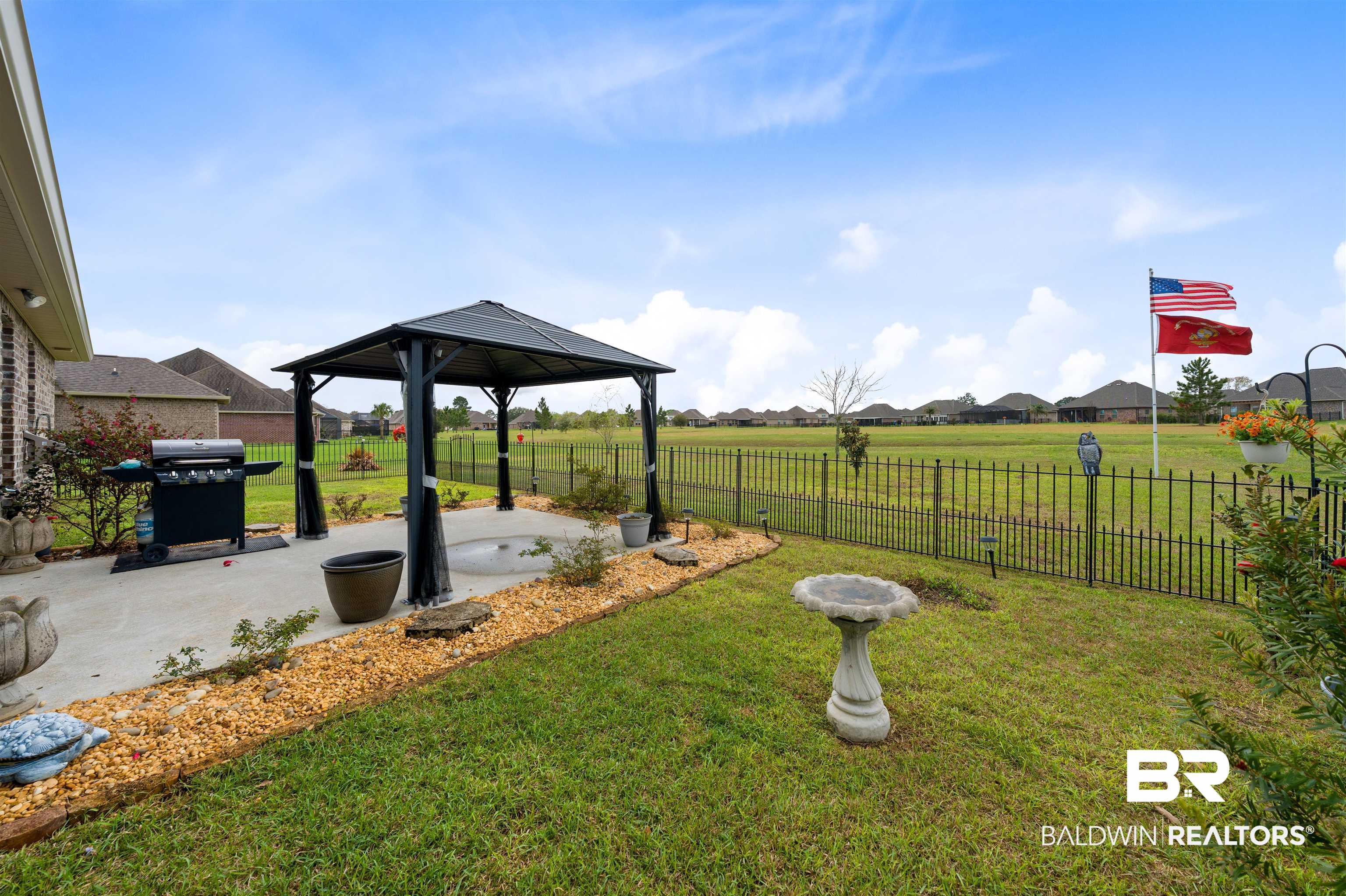 22512 Putter Lane Foley, AL 36535 - Photo 19 of 27 Fenced backyard featuring a patio area, a gazebo, and a residential view