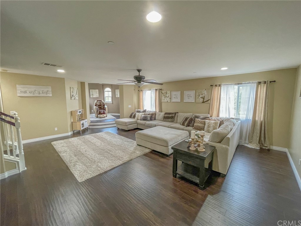 5381 Campania Way Fontana, CA 92336 - Photo 27 of 45 a living room with furniture and a wooden floor