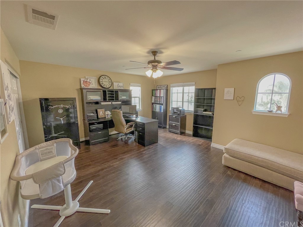 5381 Campania Way Fontana, CA 92336 - Photo 30 of 45 a living room with furniture a fireplace and a chandelier