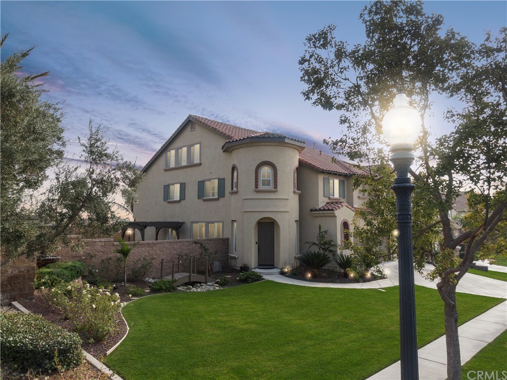 5381 Campania Way Fontana, CA 92336 - Photo 3 of 45 a front view of a house with a garden