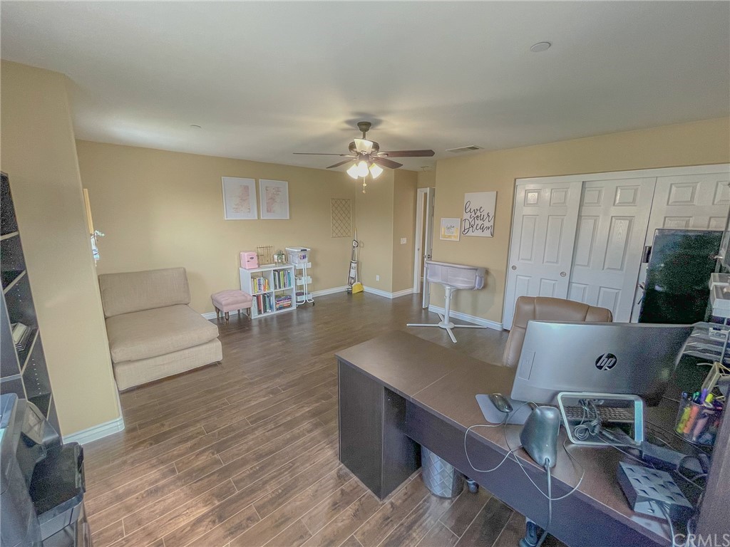 5381 Campania Way Fontana, CA 92336 - Photo 34 of 45 a workspace with furniture and wooden floor