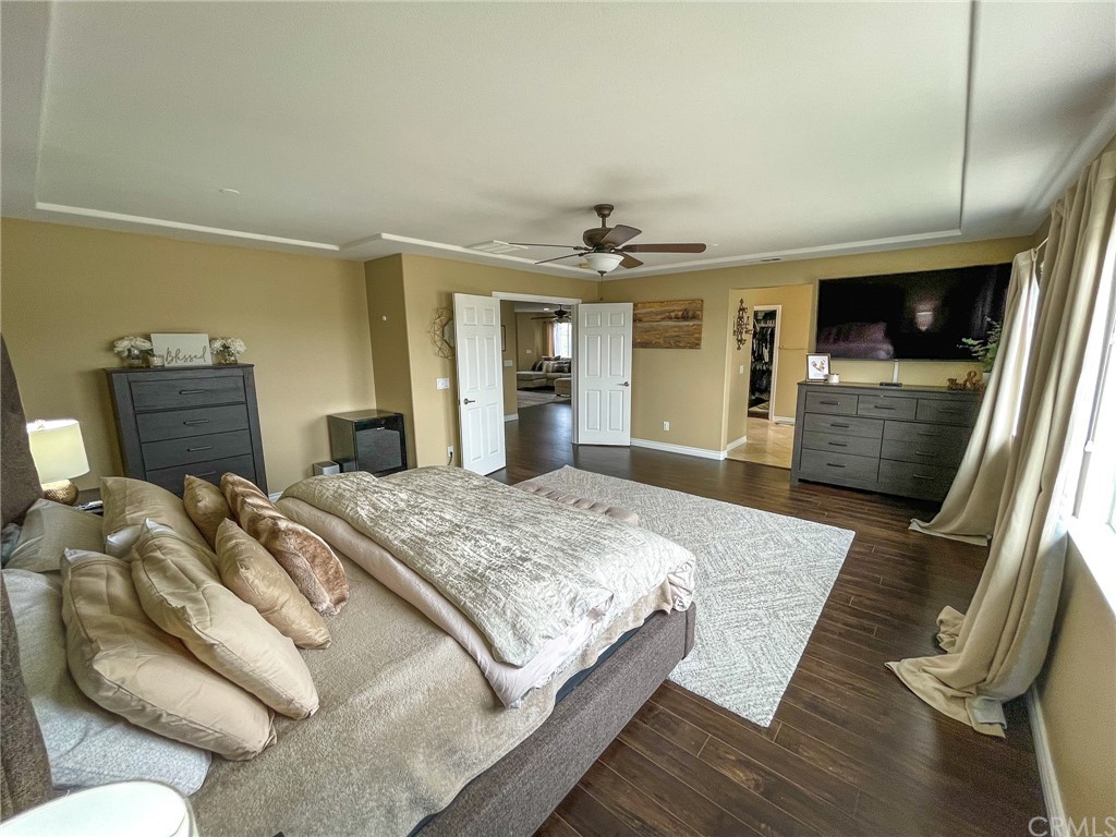 5381 Campania Way Fontana, CA 92336 - Photo 37 of 45 a bedroom with a large bed a flat tv screen and dresser