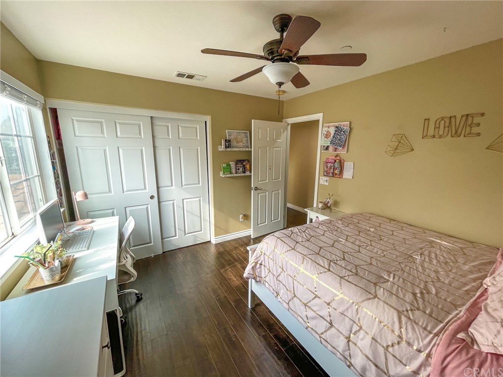 5381 Campania Way Fontana, CA 92336 - Photo 38 of 45 a bedroom with a bed ceiling fan and a wooden floor