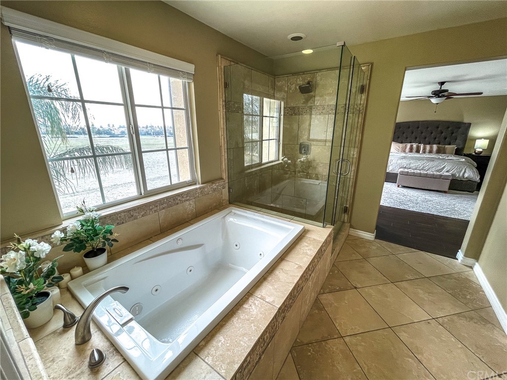 5381 Campania Way Fontana, CA 92336 - Photo 42 of 45 a bathroom with a tub sink and mirror