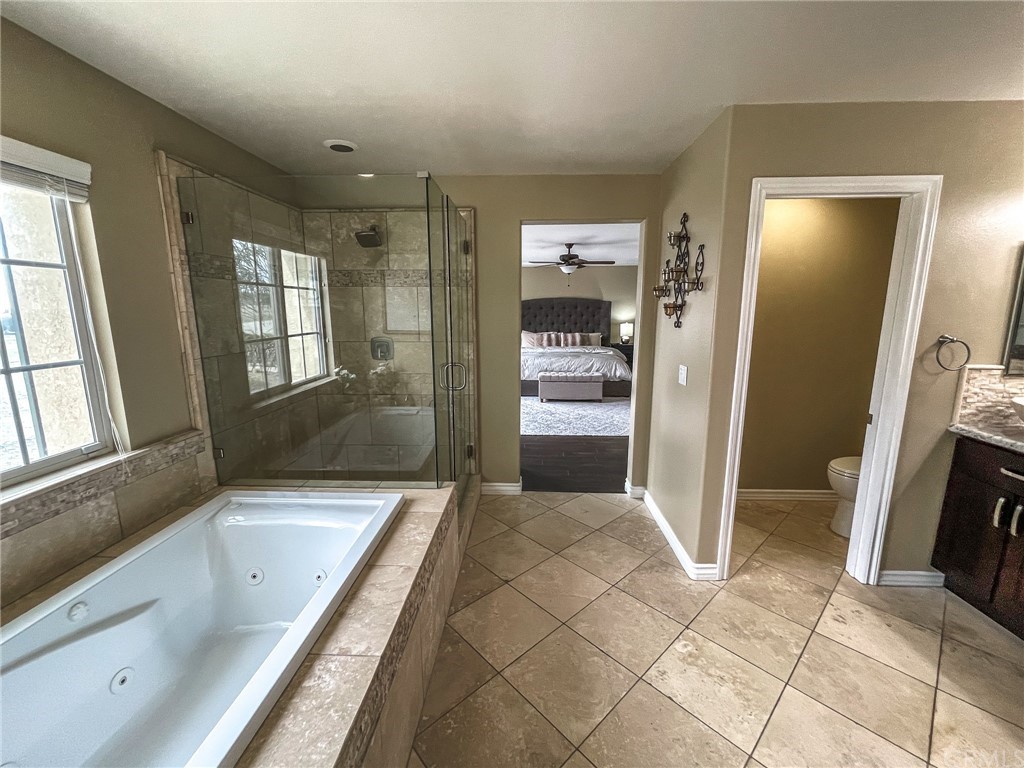 5381 Campania Way Fontana, CA 92336 - Photo 43 of 45 a bathroom with a tub shower and sink