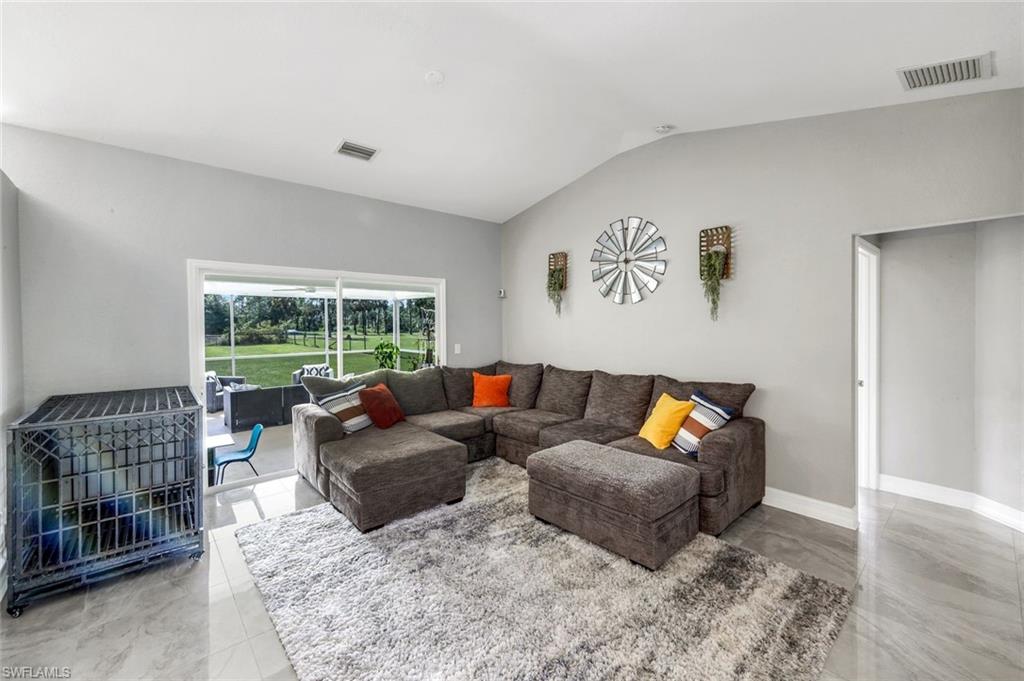 3780 12th Avenue Southeast Naples, FL 34117 - Photo 12 of 43 a living room with furniture and a window