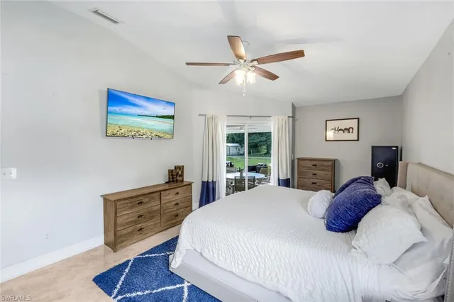 a bedroom with a bed and a painting on the wall