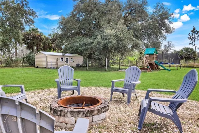 a backyard of a house with table and chairs