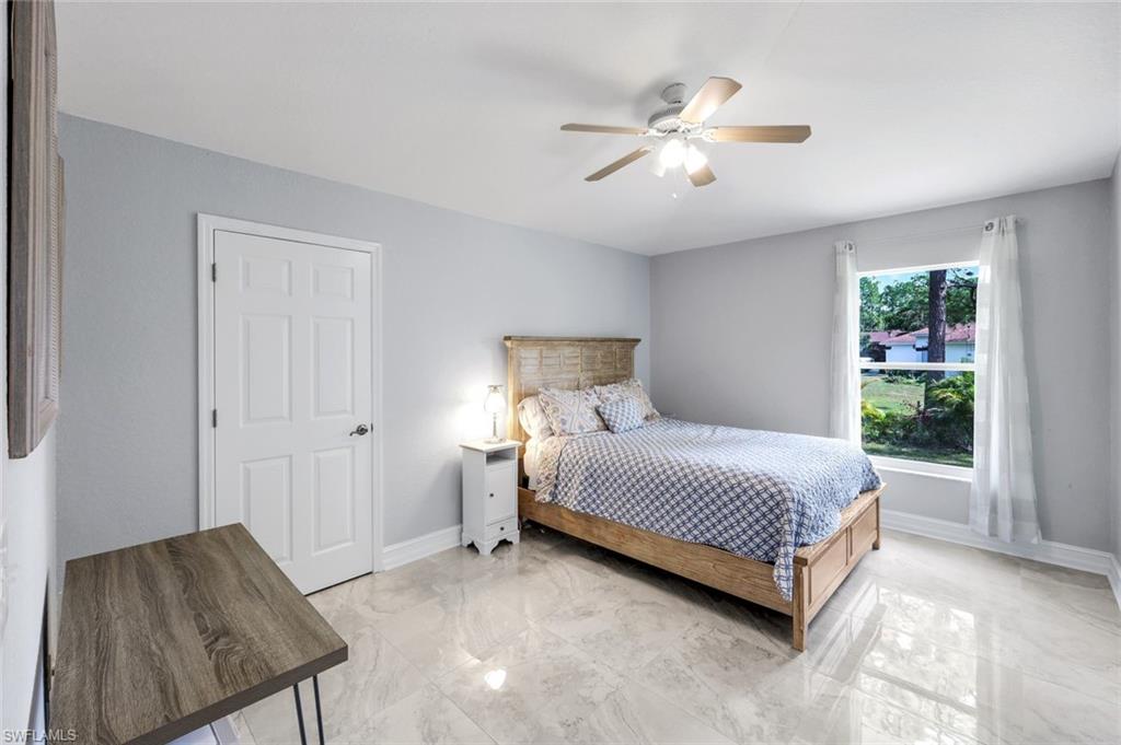 3780 12th Avenue Southeast Naples, FL 34117 - Photo 21 of 43 a spacious bedroom with a bed and a dresser