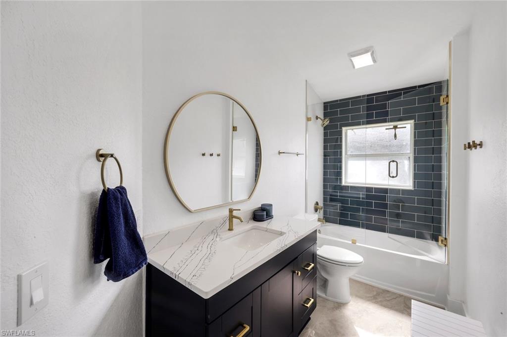 3780 12th Avenue Southeast Naples, FL 34117 - Photo 22 of 43 a bathroom with a sink a toilet and shower