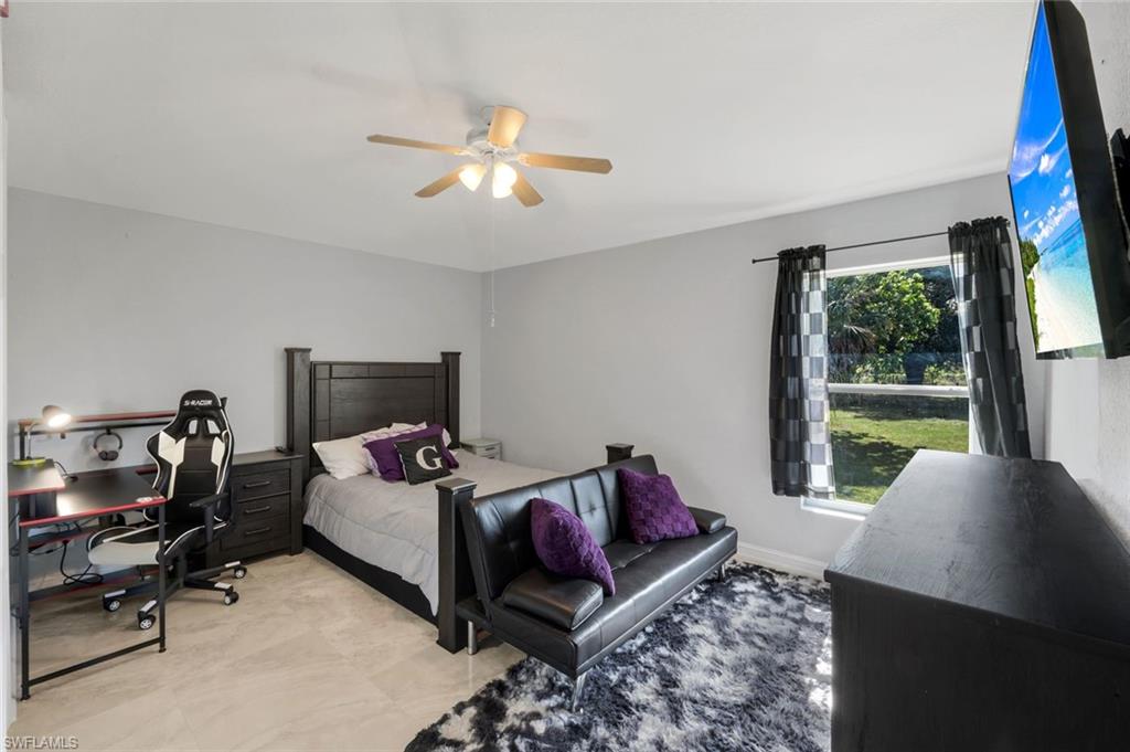 3780 12th Avenue Southeast Naples, FL 34117 - Photo 23 of 43 a living room with furniture and a flat screen tv