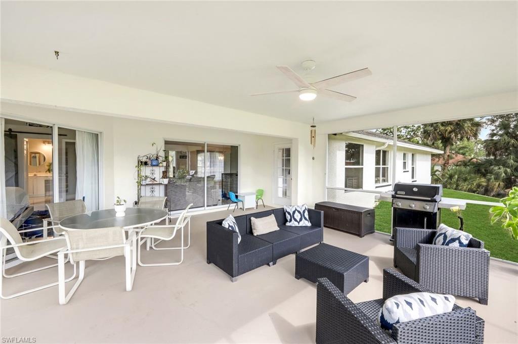 3780 12th Avenue Southeast Naples, FL 34117 - Photo 28 of 43 a living room with furniture and a table