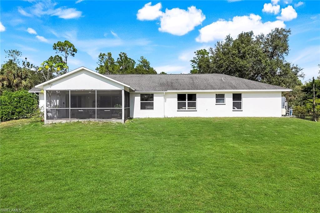 3780 12th Avenue Southeast Naples, FL 34117 - Photo 29 of 43 a front view of a house with a garden