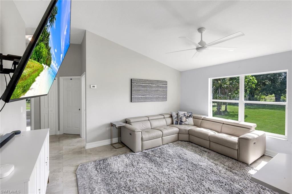 3780 12th Avenue Southeast Naples, FL 34117 - Photo 4 of 43 a living room with furniture and a large window