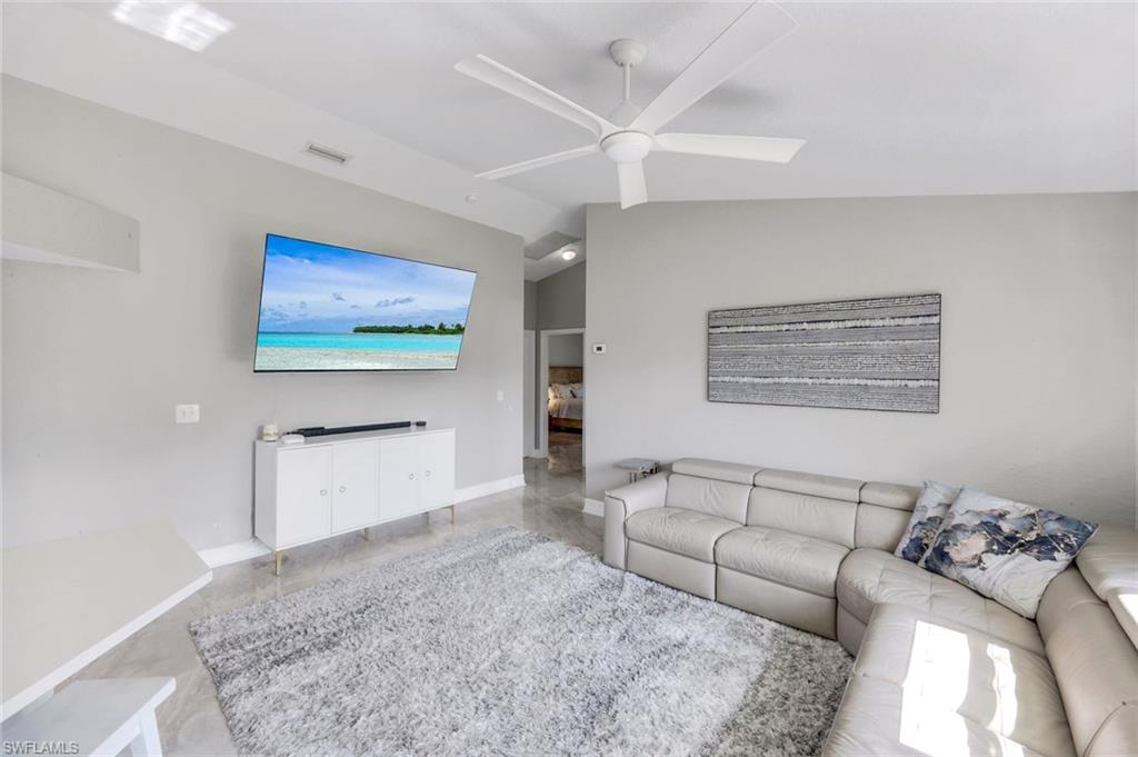 3780 12th Avenue Southeast Naples, FL 34117 - Photo 5 of 43 a living room with furniture and a flat screen tv