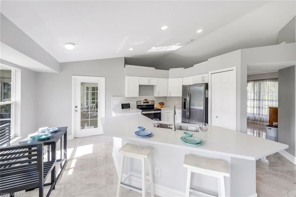 3780 12th Avenue Southeast Naples, FL 34117 - Photo 6 of 43 a kitchen with refrigerator and window